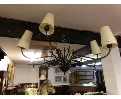 A large wrought iron ceiling light