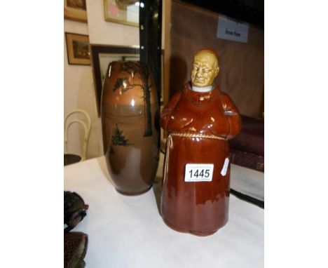 A Monk decanter and a vase
