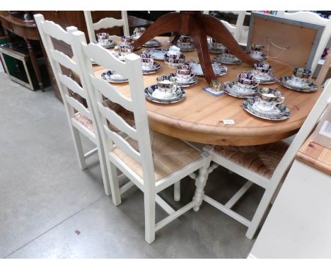 A modern painted dining table with pine top and 6 ladder back chairs