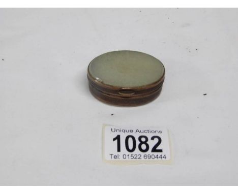 A 19th century pill box with jade to lid and base
