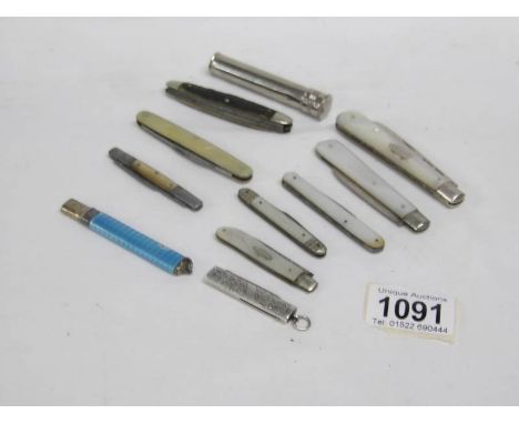 A collection of pen knives including silver and enamel