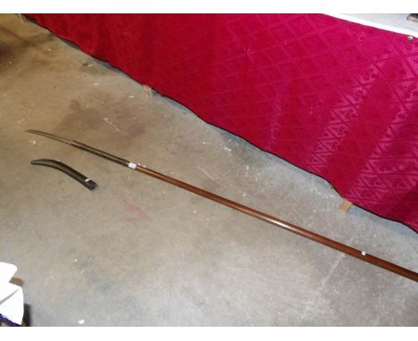 An 18th/19th century Naginata consisting of a wooden shaft with inlaid abalone shell flecks and wooden scabbard to protect th