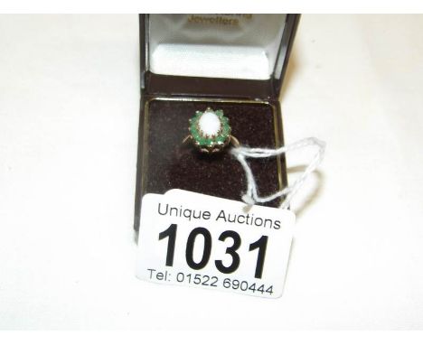 A 9ct gold ring set opal cluster, size L