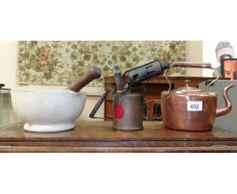 A pestle and mortar, a blow lamp and a copper kettle