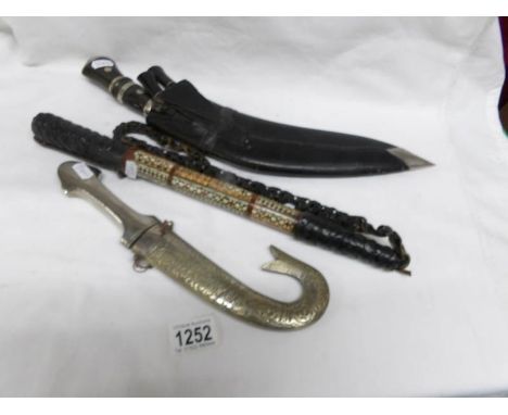 A kukri, a dagger and an inlaid bull whip