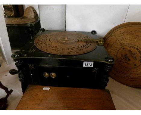 An antique Ariston ebonises polyphon with fifteen 13'' discs
