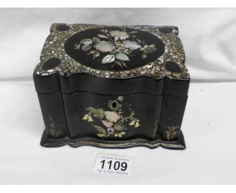A lacquered tea caddy inlaid with mother of pearl