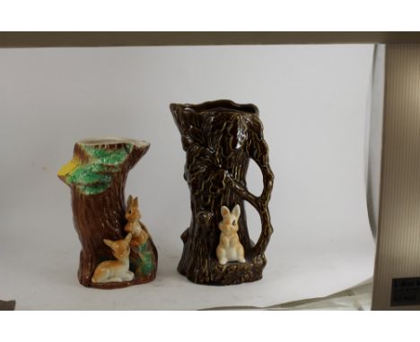 A novelty pottery vase in the form of a tree trunk and bunny and another similar 