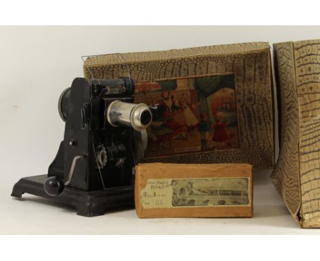 An early German tin plate Cinematograph magic lantern slide and film projector with a cased set of slides, in its original bo