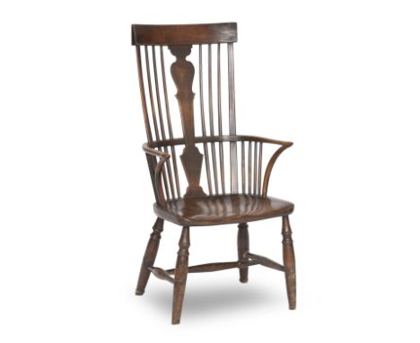 A late 19th century walnut, beech and elm comb back Windsor arm chairWith a vase shaped central splat flanked by spindles abo