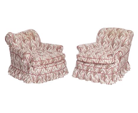 An early 20th century upholstered easy armchair together with another first half 20th century easy armchairOne with turned fr