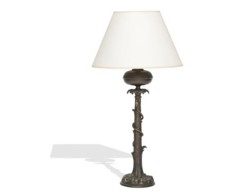 A 19th century brass paraffin lampThe reservoir on top of the column formed as a snake coiled around a tree trunk, on a natur