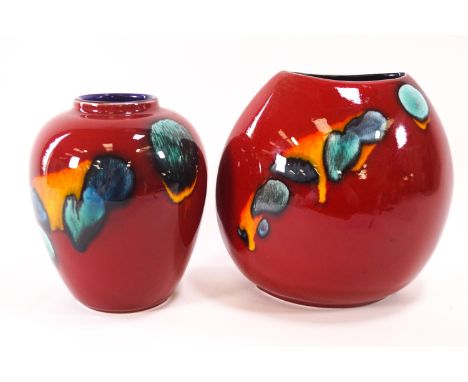 Two Poole pottery vases, both decorated in blue, green and yellow, on a red ground, the tallest 19cm high