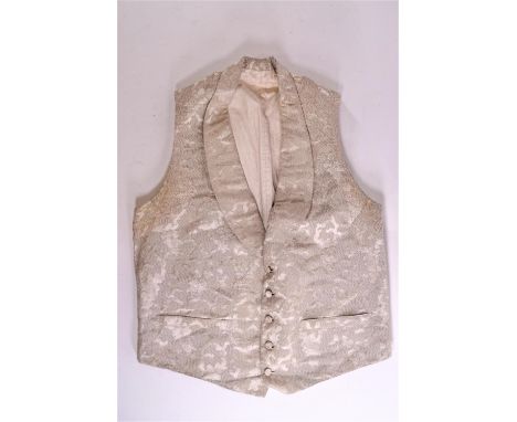 A gentleman's 19th century silver brocade waistcoat with shawl collar and five fabric button front and a 19th century black l