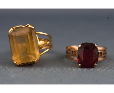 A yellow metal single stone ring set with a rectangular citrine size M, together with a rose metal garnet dress ring size N. 