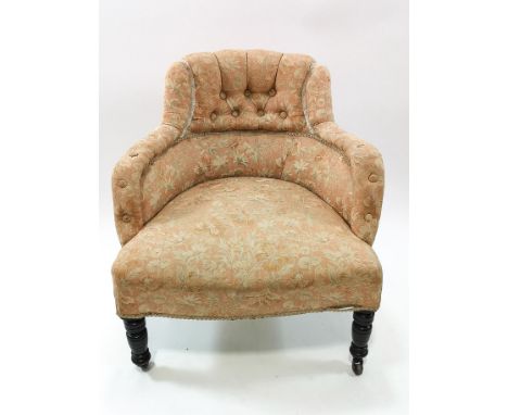 A Victorian nursing chair with button back on turned ebonised legs