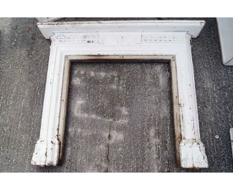 A 19th century cast iron fire surround with plain shelf over a central panel raised on stepped framed sides with cut columns 