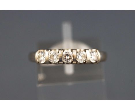 A white metal half hoop ring. Set with five round faceted cut diamonds of approx. total weight: 0.63cts. Shank stamped 'The L