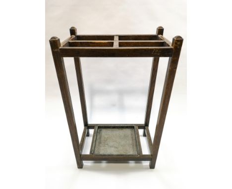 An oak stick stand with four section divides, 71cm high x 43cm wide x 27cm deep