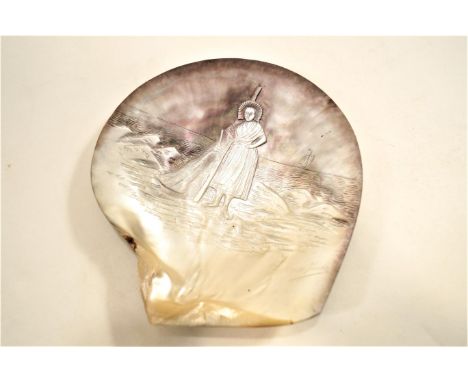 A carved shell, Saintly figure in a seascape, signed bottom right, Boulogne Ymes, 17cm long x 15.5cm wide