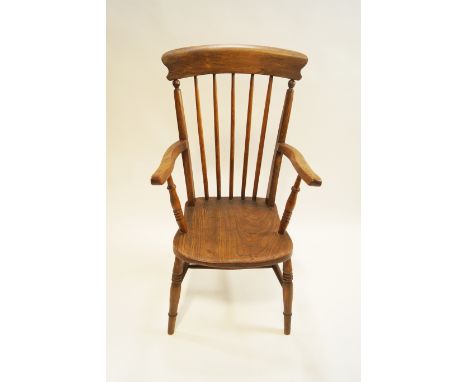 A 19th century ash stick back elbow chair, on turned tapering legs linked by an H stretcher