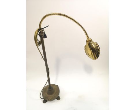 A brass desk lamp with shell shaped shade on round base with paw feet, the column only 75cm high