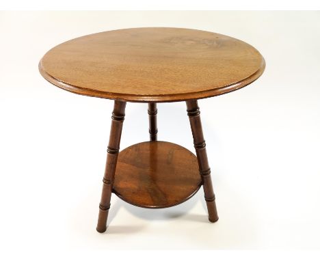 A late 19th century mahogany occasional table, the round top on three turned legs linked by a round under shelf, 42cm high x 