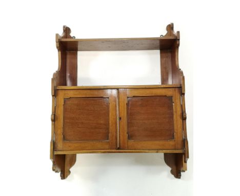 A Victorian mahogany two tier hanging wall shelf with two panelled doors overall 84cm high x 61cm wide x 23cm deep