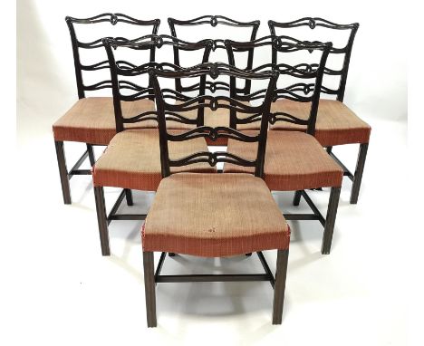 A set of eight mahogany dining chairs each with pierced ladder backs, stuff over seats and reeded square legs, two with arms