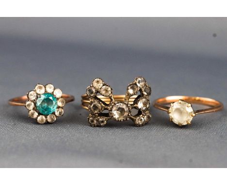 A collection of three yellow metal dress rings set with white sapphires/zircons and blue zircon (untested) Not hallmarked - t