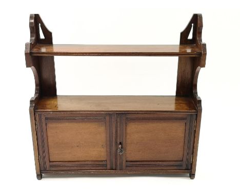 A 19th century mahogany hanging two tier wall shelf above two panelled doors, 62cm high x 62cm wide x 16cm deep