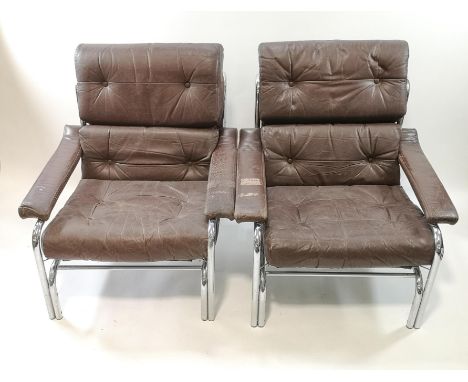 A pair of chrome framed armchairs, with button backs and loose seat cushions