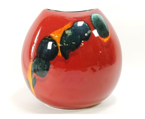 A Poole pottery vase of ovoid form, decorated with green yellow glaze on a red ground, moulded factory marks