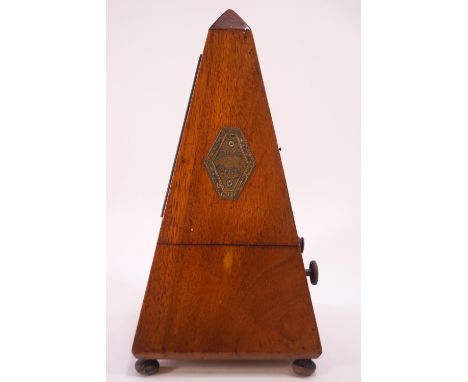 A French mahogany cased metronome, on bun feet, 23cm high