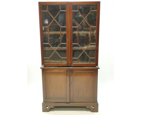 A 19th century mahogany standing corner cabinet, with two glazed doors above two panelled doors, on pierced bracket feet, 205