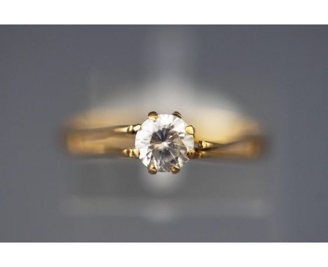 A yellow metal single stone ring set with a round faceted cut cubic zirconia. Hallmarked 9ct gold, Birmingham, 1981. Size: M,