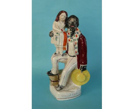 Uncle Tom and Eva: a Staffordshire group, Eva depicted standing on the thigh of a seated Tom, the base titled, circa 1852, 26