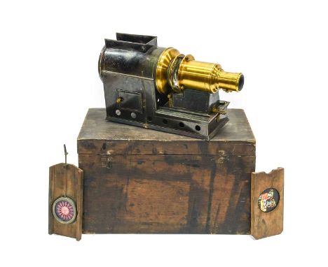 Magic Lantern with unmarked brass lens and tinplate body in original (?) wooden box, together with three lantern slides inclu