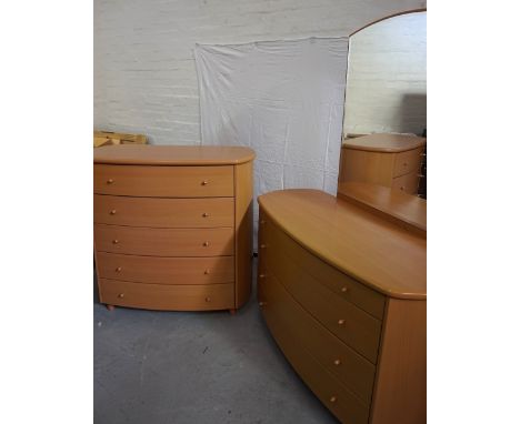 BEECH BOW FRONT DRESSING CHESTwith a shaped bevelled mirror back above four drawers, standing on stout turned supports, 172cm