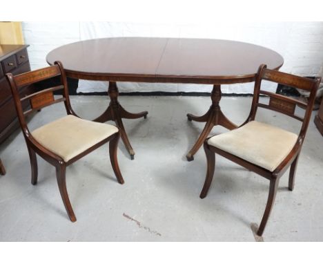 EDWARDIAN STYLE MAHOGANY DINING SUITEcomprising a table, 184cm long x 115cm wide, raised on a double tripod pedestal with spl