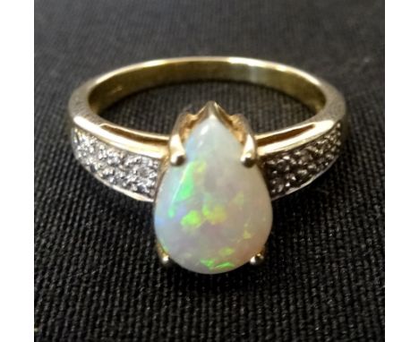 OPAL AND DIAMOND DRESS RINGthe pear shaped cabochon opal flanked by diamond set shoulders, on nine carat gold shank, ring siz