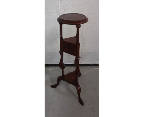 MAHOGANY PLANTSTANDwith circular top, above two triangular drawers, above an undertier, all raised on tall shaped supports wi