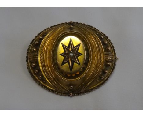 VICTORIAN UNMARKED GOLD BROOCHwith central pearl surrounded by blue enamel star, the reverse with glazed panel, 4.3cm wide
