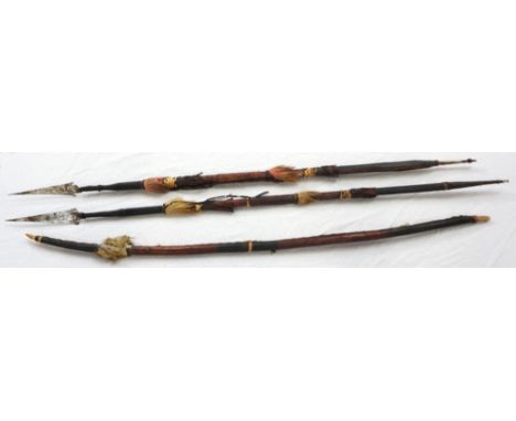 TWO SOUVENIR AFRICAN SPEARSwith steel arrow head shaped blades on a wooden shaft covered in leather with tassels, 132.5 cm an