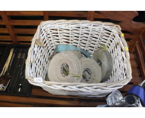 A wicker basket containing ratchet straps