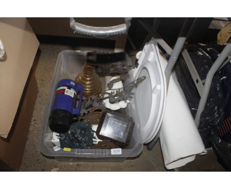 A box containing Thermos flask, metal sculpture, solar powered lights, toilet seat etc.