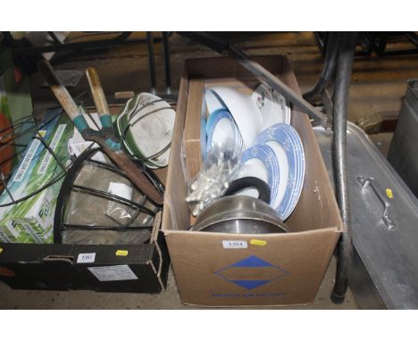 A box containing plastic plates cutlery, placemats, kettle etc. 