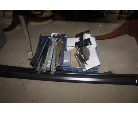 Two boxes containing sheet music stands, camera tripod, a screen, door handles etc.