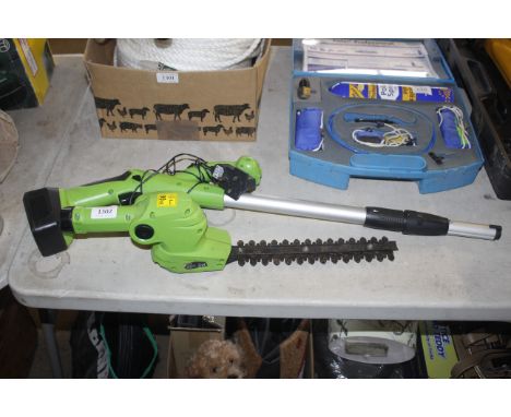 A Handy electric extending hedge trimmer with battery and charger 