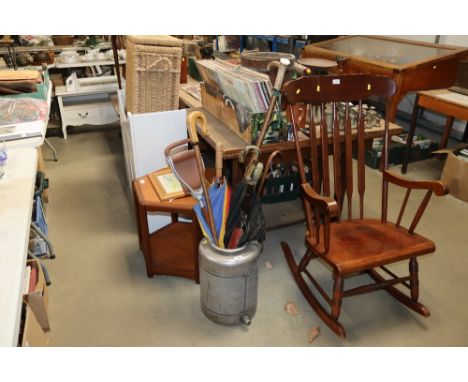 A metal urn and contents to include walking sticks, umbrellas and a shooting stick